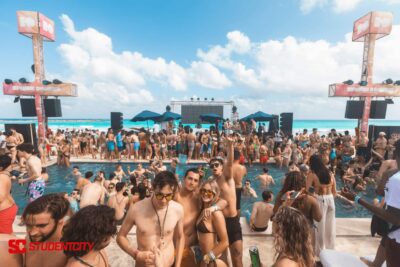 Students enjoying their spring break getaway on a beach.