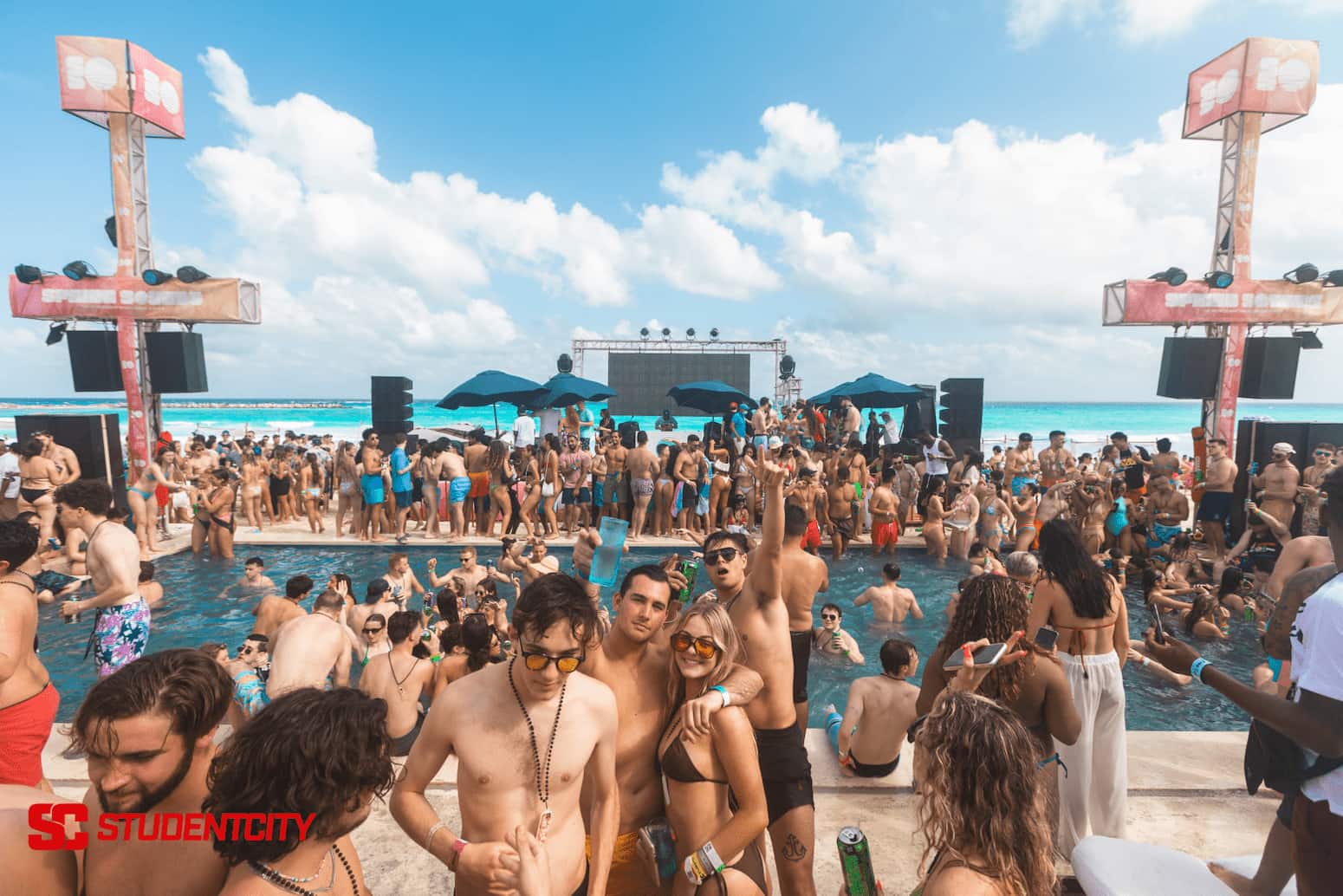 Students enjoying their spring break getaway on a beach.